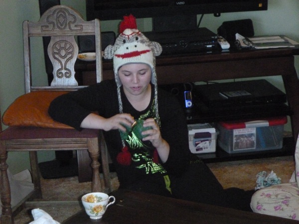 Caitlin opens the teeny package